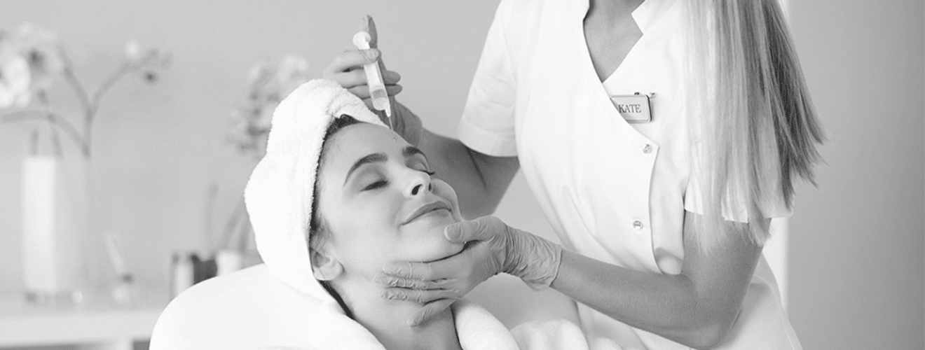 Facial mesotherapy application: Woman receiving micro-injections for skin rejuvenation and revitalization.