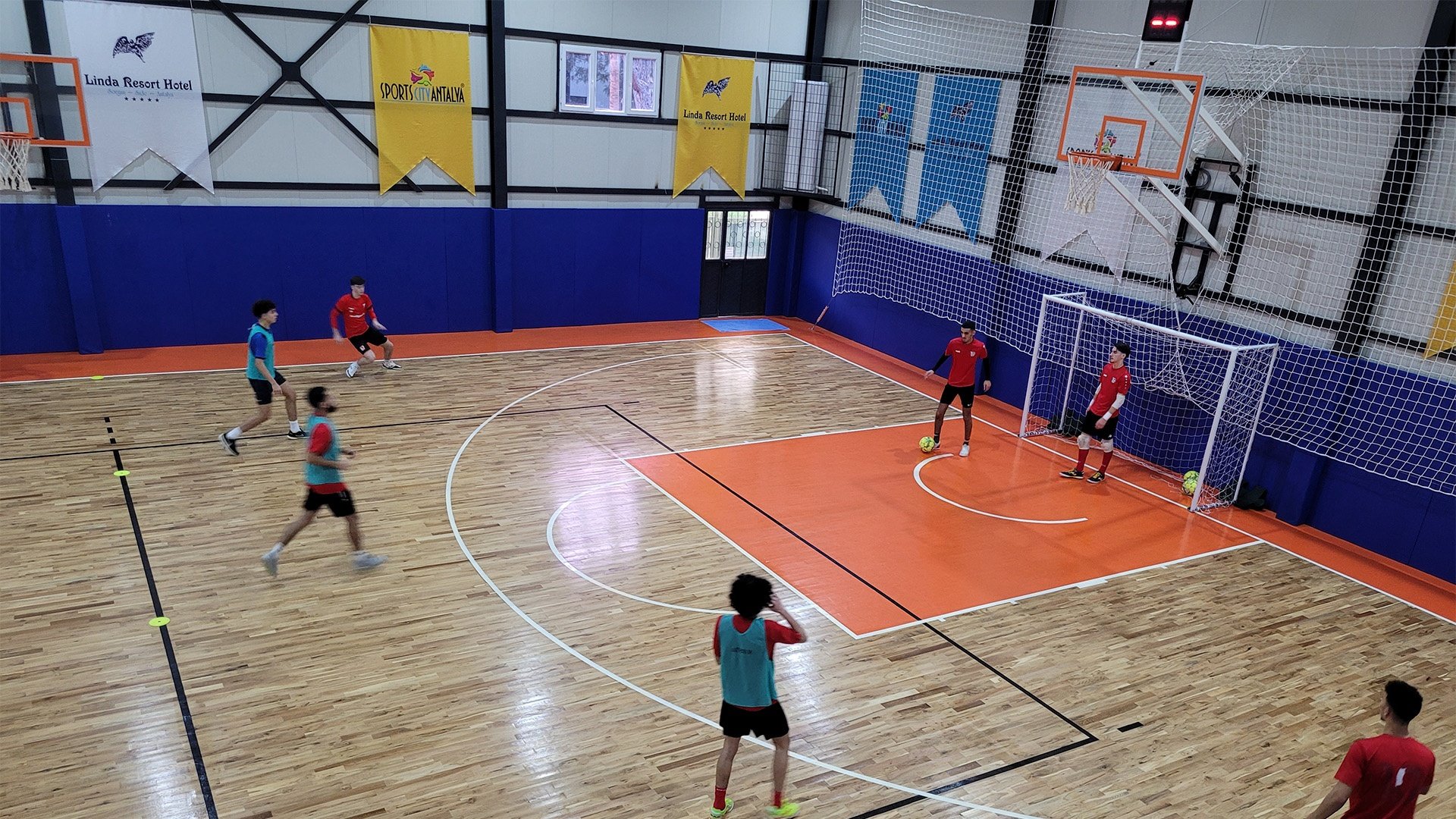 Young futsal players improving football skills through indoor training