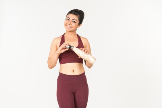 young-indian-woman-in-sportswear-holding-sport-bottle.
