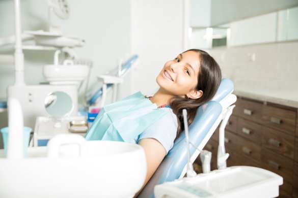 portrait-smiling-teenage-girl-with-braces-sitting-chai
