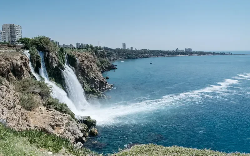 Waterfall plunging from the cliffs into the sea