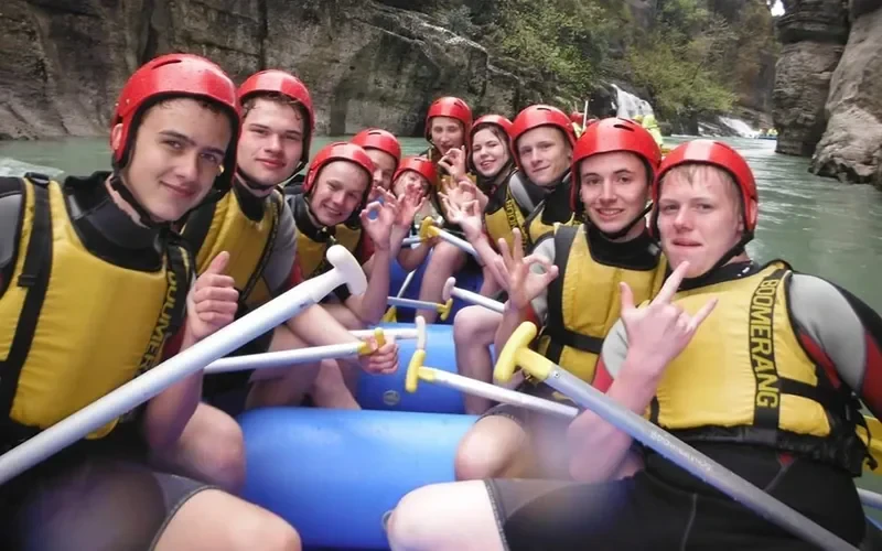 Smiling group in red helmets in the raft – Kadriye Rafting Prices