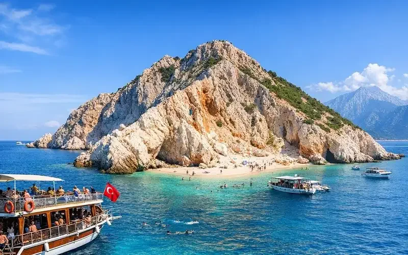 Excursion boat anchored off Suluada island with swimmers in turquoise water near Adrasan, Antalya