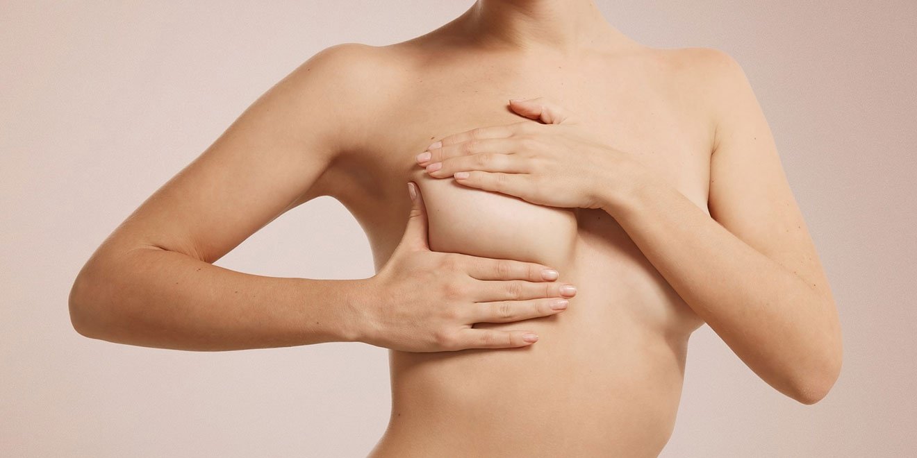 Woman with significant breast sagging requiring risk assessment for a combined breast lift and augmentation.