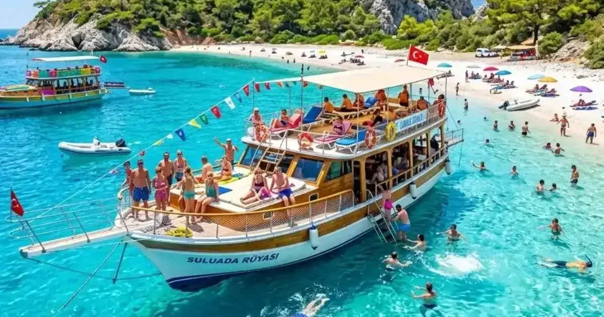 Tour boat anchored in a turquoise bay near Antalya with guests swimming – boat tour deals and discounts