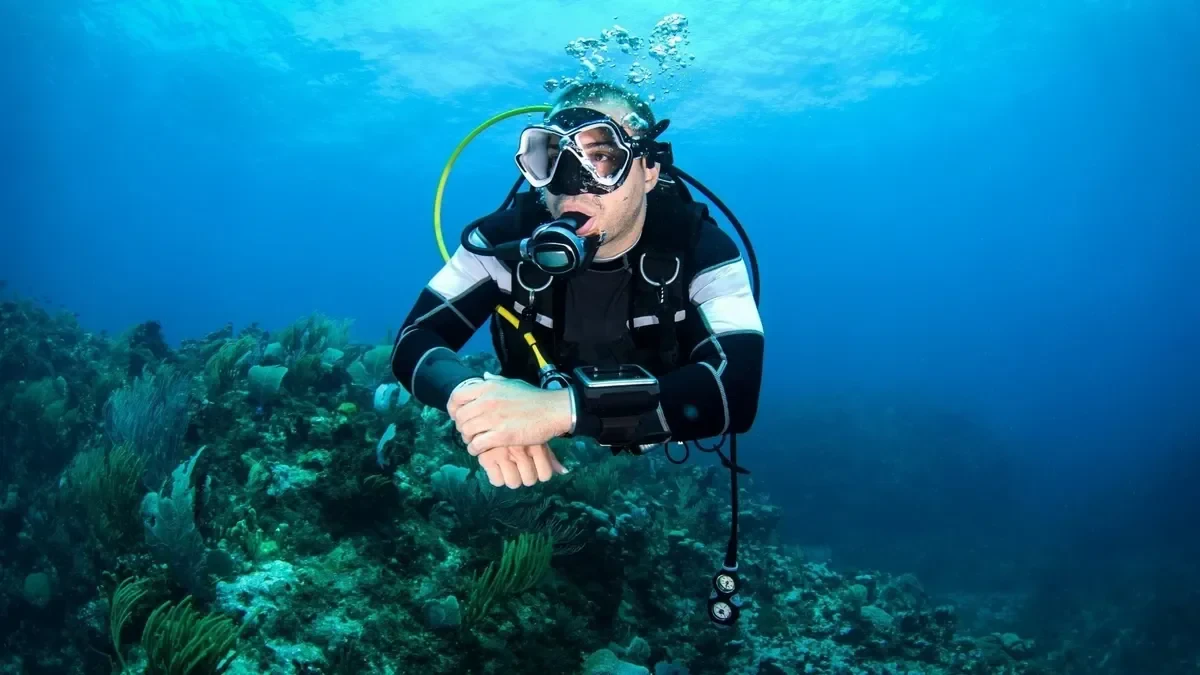 Taucher schwebt im klaren blauen Wasser