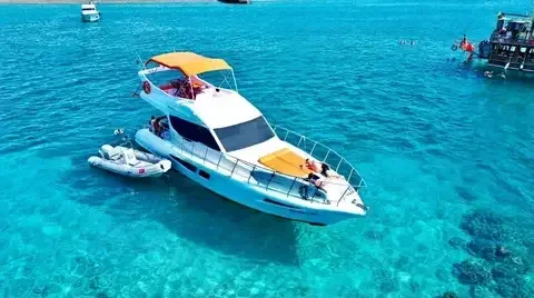 Weiße private Motoryacht ankert in türkisfarbenem Wasser – Yachtvermietung in Antalya